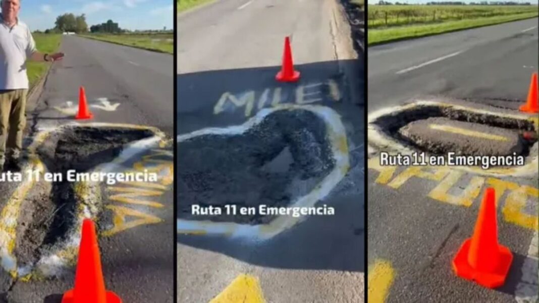 Transportista marca baches con pintura amarilla en la Ruta Nacional 11 cerca de San Justo, Santa Fe.